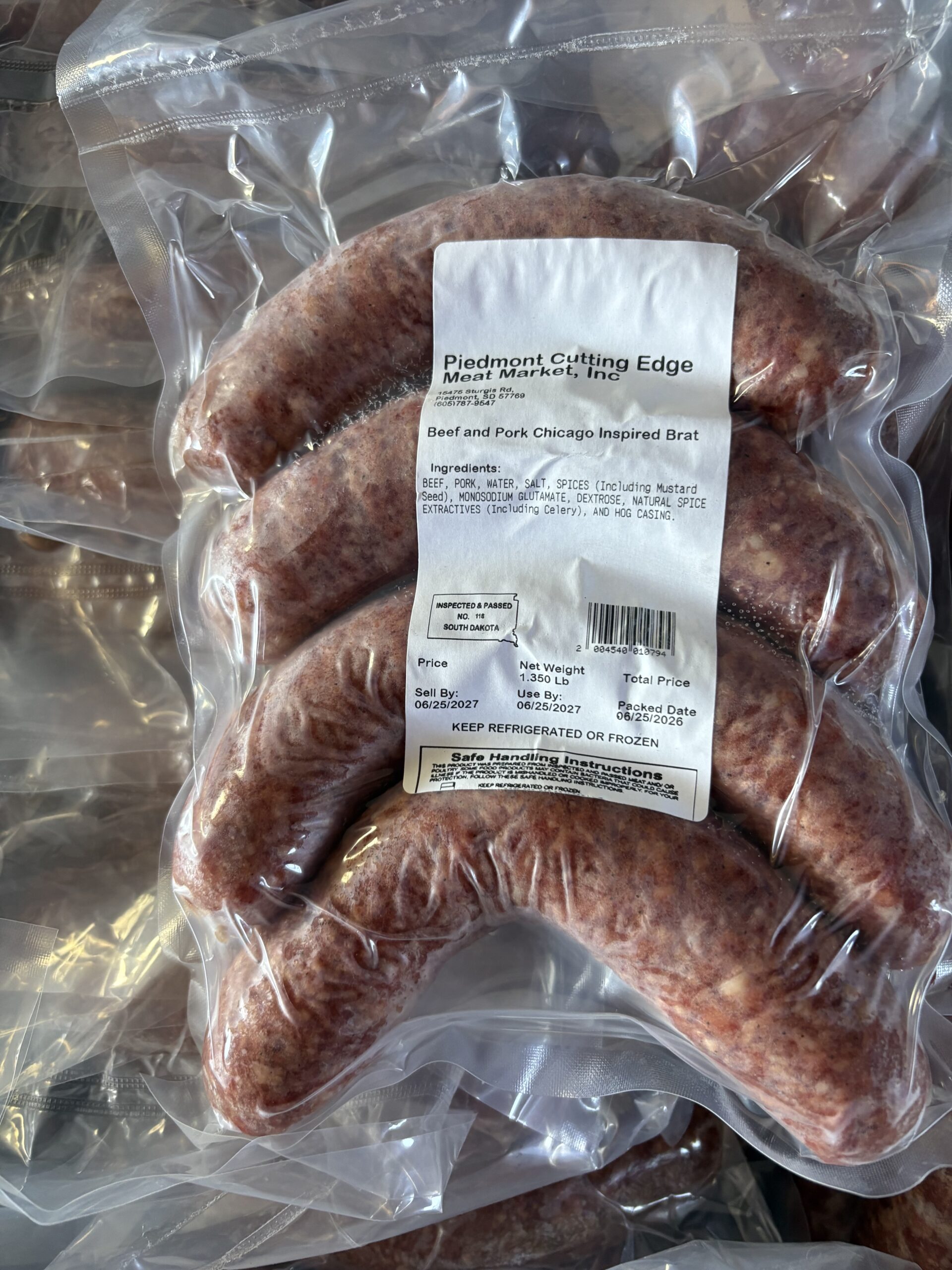 Beef and pork Chicago-inspired bratwurst sausages packaged in vacuum-sealed bags, featuring a label with ingredients, net weight, and handling instructions from Piedmont Cutting Edge Meat Market.
